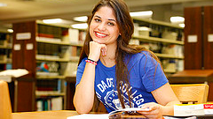 An MDC student poses for a picture in the library