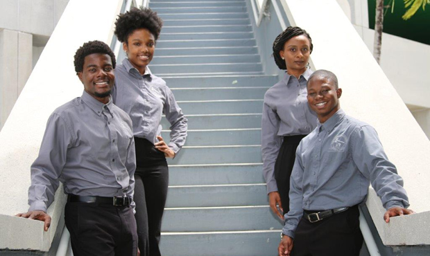 Four student govenment members stand together by a staircase