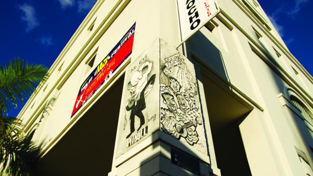 Side of building displaying Urbana poster