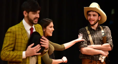Students on stage performing Oklahoma