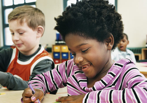 Child playing with crayons