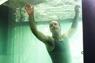 Performer making bed underwater