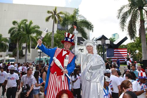 People in costume as Uncle Sam and the Statue of Liberty