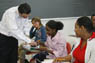 A professor instructs students in a classroom.