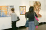 Viewers enjoy a gallery exhibition.