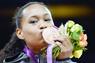 Paige McPherson kissing her medal