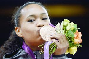 Paige McPherson kissing her medal