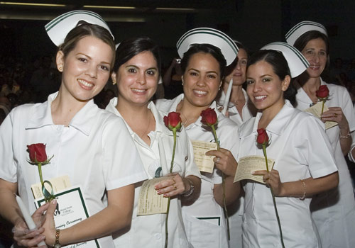 Nursing students celebrate at a lighting ceremony.