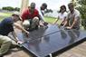 Students installing solar panels