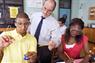 Students performing lab experiment with teacher watching