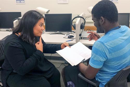 An MDC student tutoring a hearing impaired student