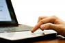 Finger on laptop trackpad