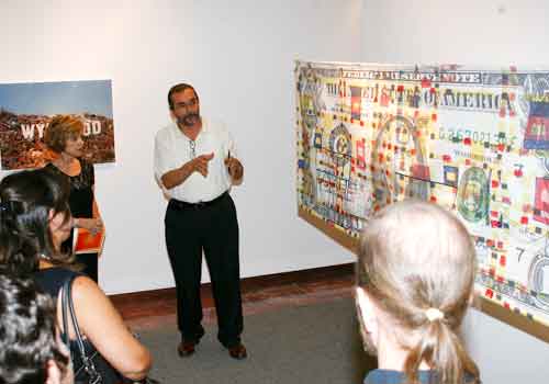 Patrons hear about the artwork in 'Miami: City – Metaphor' during the opening night of the exhibition.