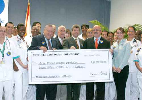 Donors, College leaders and students with an $11 million check