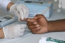 Student clinician checks patient's blood sugar