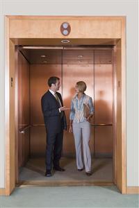 Co-workers standing in elevator