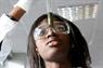Student looking at test tube