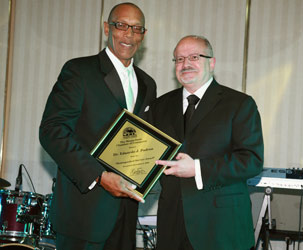 Eric Knowles, chairman of the Miami-Dade Chamber of Commerce, presented a Distinguished Service Award to MDC President Dr. Eduardo J. Padrón.