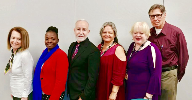 Writing Lab personnel line up for a photo