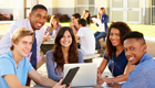 Students gathered around a laptop