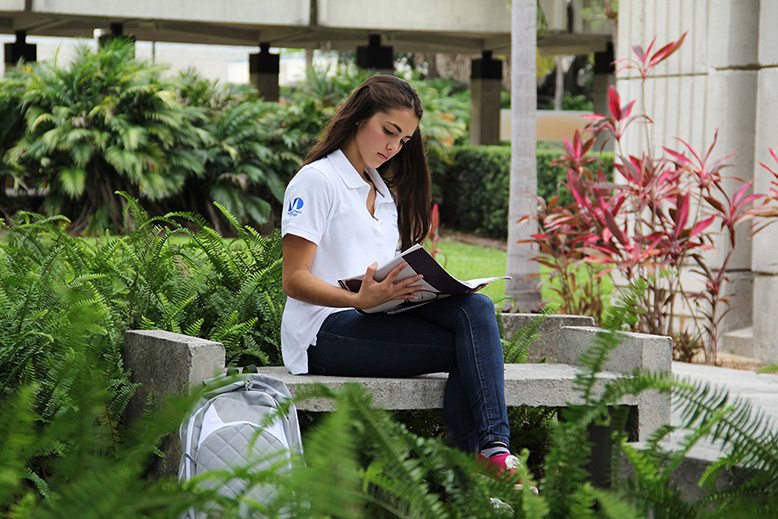 Student reading on campus