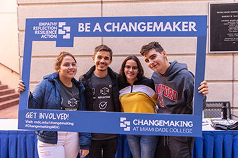 Four students posing for a photo for social media