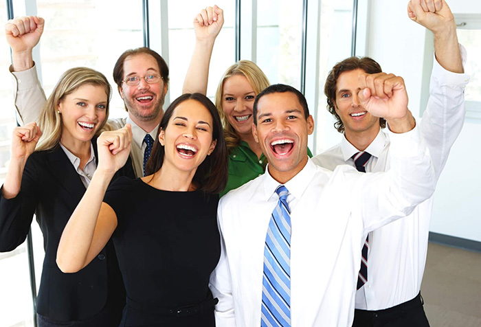 Diverse group of people in business attire celebrating