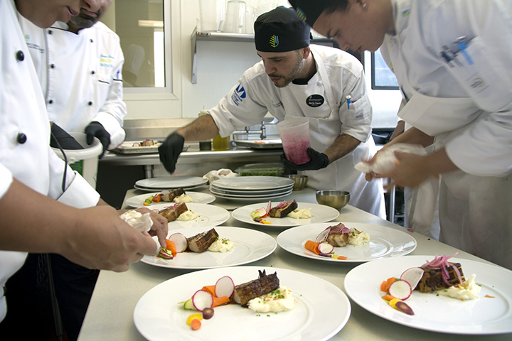 Chef and students preparing main course