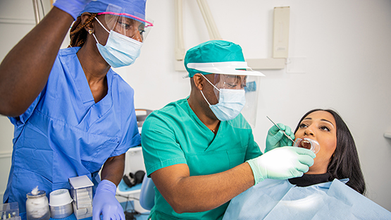 Dental Assistant helping a Dentist with a patient