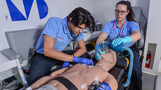 Emergency Medical Technicians examining patient