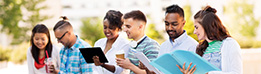 Diverse group of students holding documents while having a conversation