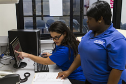 Student learns health information technology with a trainer