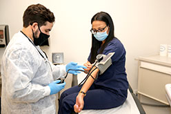 Student measuring blood pressure