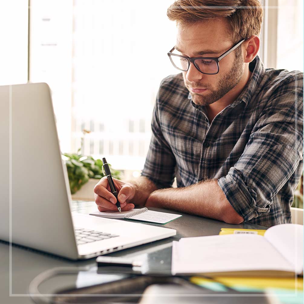 Photo of an adult male taking notes