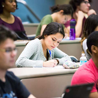 Stundent taking notes at a class