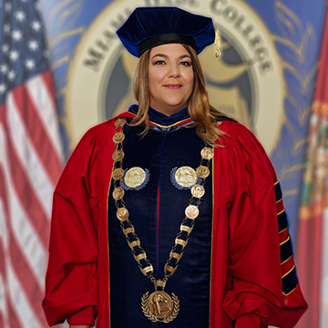 President Madeline Pumariega waering the academic regalia