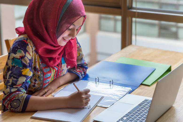 Student studying from her laptop at the library