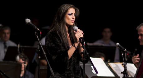 Female jazz singer performing with an orchestra
