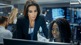 professor explaining to student in front of computer screen