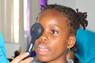 Student performing eye exam