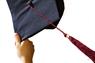 Hand holding up graduation cap