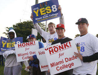 Miami Dade College students hold signs in support of Amendment 8.