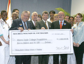 Donors, College administrators and students with an $11 million check