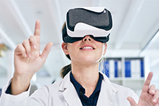 A student wearing a lab coat using a VR headset