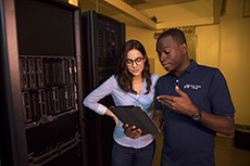 Two students in a server room working together