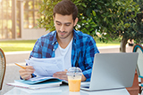 Male student looking through documents