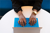 Hands laying on top of the keyboard of a laptop