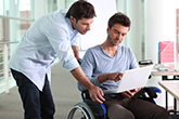 Two students looking at a laptop screen