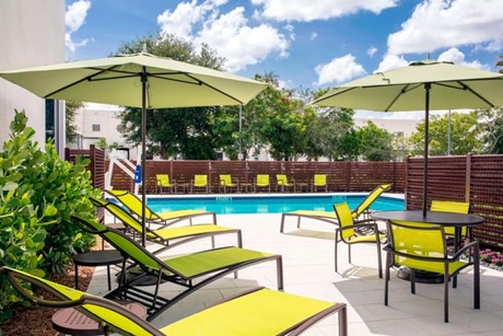 Outside of hotel showing chairs and swimming pool