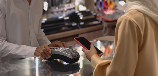 A person paying at the cashier with a phone